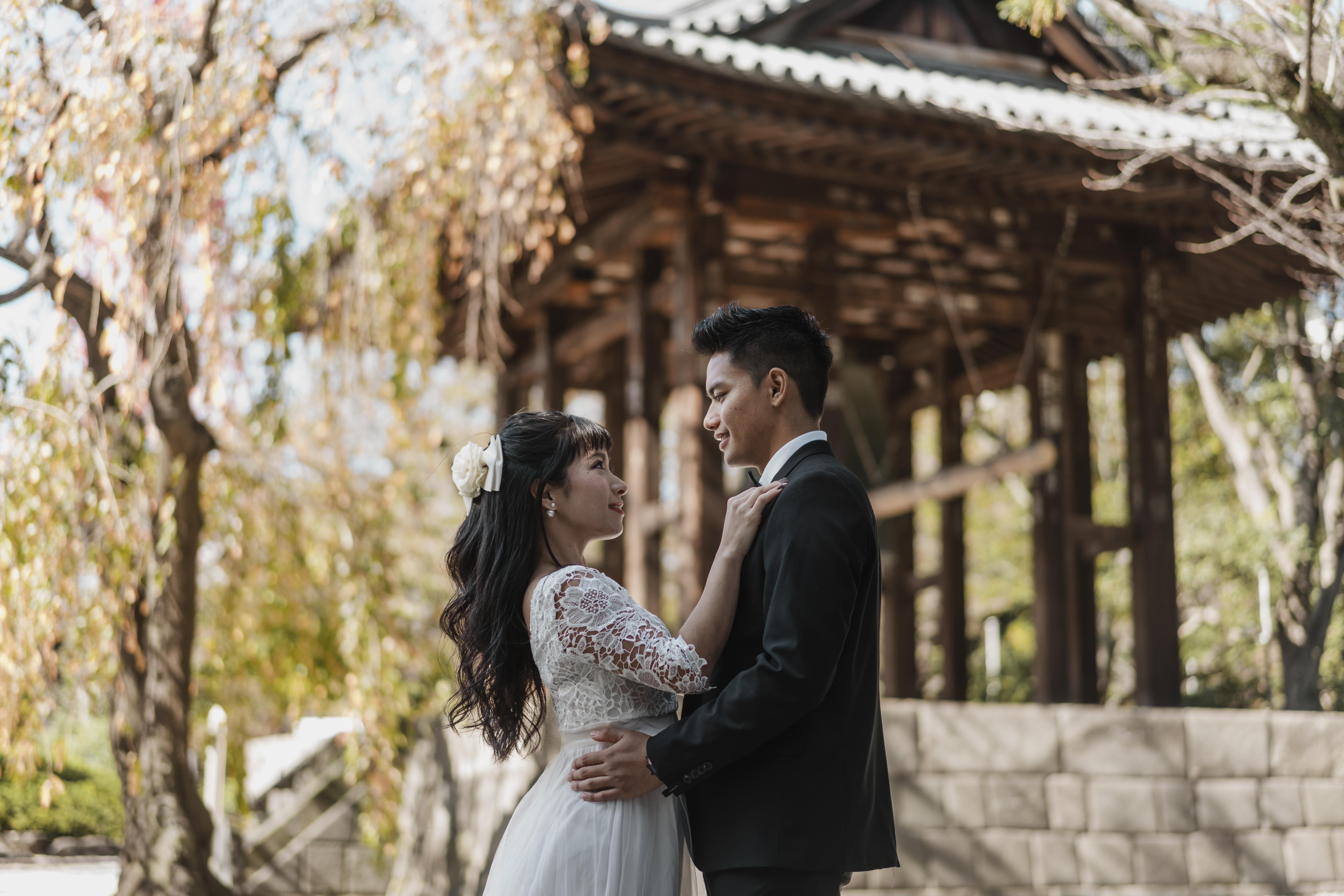 side-view-groom-bride-embraced-outdoors